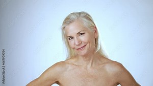 Portrait of happy smiling attractive mature natural woman looking at camera. Advertising of body care spa procedures concept.