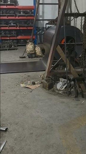 The shearing machine is cutting steel.