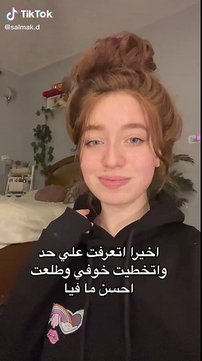 Person in Rainbow Hoodie Gestures in Domestic Setting