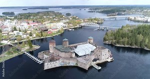 Olavinlinna, Cinema 4k aerial flying over olavinlinna medieval castle and tilting down above, in Savo, Finland
