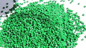 Plastic pellets . The dye granules for polypropylene polystyrene falling on a light background