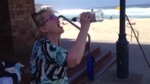 Woman Struggles with Water Bottle