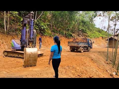 The young woman hired an excavator to level the ground around her house.