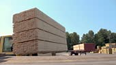 This shot features a fork lift loading timber beams and placing them...
