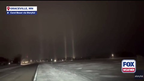 Wintry weather triggers light pillar phenomenon as light beams illuminate the sky in Graceville, Minnesota