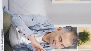 Vertical video of Longingly the man looks at the photo on the phone.