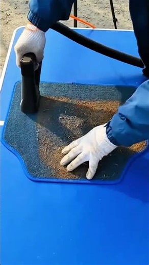 cleaning the dusty surface of a car floor mat using a vacuum machine #shorts