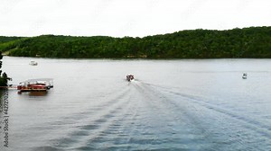 Drone following a pontoon boat on the Lake of the Ozarks in Missouri.