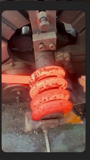 Making a metal spring with careful shaping and tension control