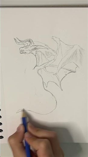 Drawing a red dragon 🐉 with thorns on its head ( forgot one thorn on the wing )