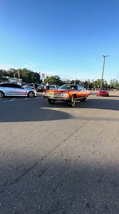 Candy tangerine Chevy fastback on 26's