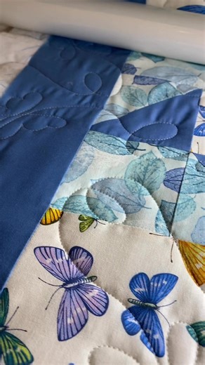 We might be in the middle of winter, but this pretty quilt with dainty colorful butterflies is reminding me Spring will be coming! In addition to beautiful quality fabrics, sewing notions, and a variety of quilt patterns, we offer long arm service. Our Baby Lock Regalia has hundreds of unique edge to edge designs that will give the perfect finishing touch and truly showcase your beautiful quilt top! We carry and use Dream Cotton batting, offer a wide variety of thread colors to choose from, and 