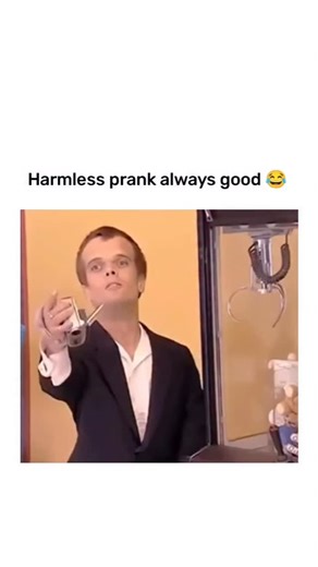 @cs2nigg on Instagram: "This vertical video clip, captioned “Harmless prank always good 😂,” features a comedic sketch involving a man (who appears to have dwarfism) performing a proposal prank on unsuspecting women in a public place, while another man secretly films their reactions. 1. The Setup: A man in a suit approaches a woman who is sitting and reading a newspaper. He kneels, opens a ring box, and offers her a bouquet of roses. 2. The Reaction: The woman is initially surprised and looks co