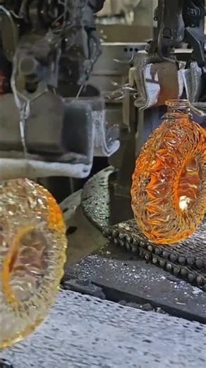 The process of making glass bottles using a sophisticated machine operated by a worker