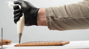 Christmas gingerbread in the shape of a house. Assembling a gingerbread house before Christmas with sugar icing.