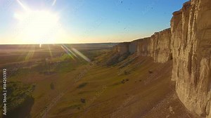 Aerial view: Rock Canyons Aerial flight going in between high rocks birds fly around active structures flying in front camera authentic view top