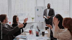 African American conference speaker coach talk to audience give presentation on flipchart to employees group, trainer manager speaking training diverse corporate team at office meeting seminar