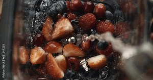 Smoothie Preparation - Berries and Water Splash. Blender Splash with Mixed Fruits