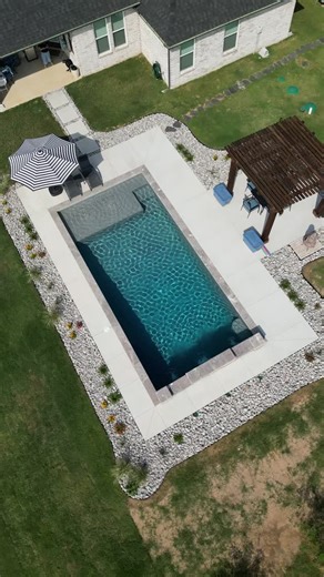 18 reactions | From concept to completion — this pool turned out absolutely stunning!  With a relaxing tanning ledge, elegant sheer descents, and a stylish pergola, this backyard is made for sunshine, splashing, and good times all summer long. ☀️ #EmeraldCustomPools #DreamBackyard #CustomPoolDesign #OutdoorLiving #LuxuryPools #BackyardBliss #PoolGoals | Emerald Custom Pools | Facebook