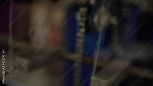 Zoomed in video showing how machine work inside a factory, its thread can be seen spinning at speed as it works toward the producing finished goods.