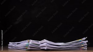 4K-Stop motion Stack overload document report paper with colorful paperclip on black background, business concept footage paperless used.