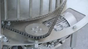 Gear wheel is driving a mechanical chain for some motion on industrial mechanism