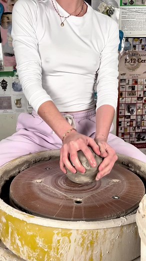 Mastering Pottery: A Young Artisan at the Wheel