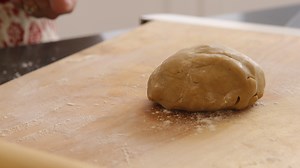Download Using rolling pin to roll cookie dough for free