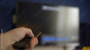 Watching tv and using TV remote control in 4k Stock Video