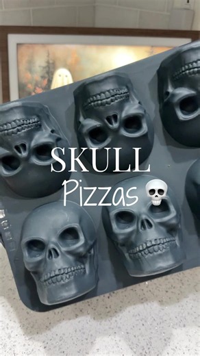 Pizza Skulls💀 These make for a fun, quick dinner! Comment SKULL for the pan I used! Press dough into pan, add sauce, cheese, and any toppings you like. Bake at 375 for 20 mins. These freeze great too! #pizza #halloweenfood #foodforkids #halloweenideas #skulls