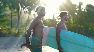 clip-1031147549-shirtless-young-attractive-surfer-males-stretching-before