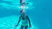 Pretty little 8s adorable girl wear swimsuit and goggles looking at...