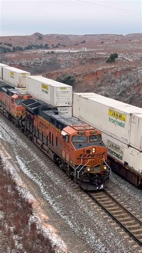 BNSF Intermodal and oil trains meeting in the snow on Curtis Hill!