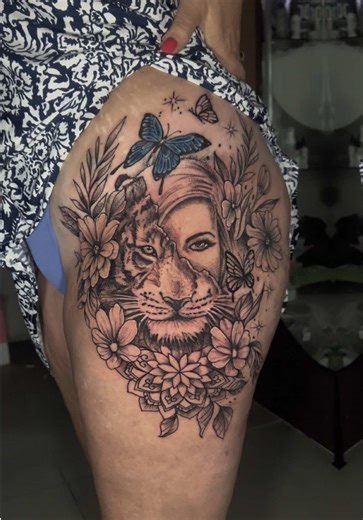 Half woman, half tiger. Strength meets softness. This floral black and grey tattoo blends feminine beauty with wild power, featuring detailed mandala elements, fine line florals, and smooth black ink shading. A symbolic design representing balance, intuition, resilience, and inner strength, perfectly placed on the thigh for maximum flow and impact. Thinking about a custom floral tattoo, mandala tattoo, or realistic black and grey piece? Our artists specialise in bespoke designs made just for you