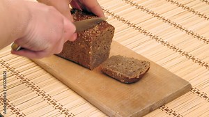 The close-up of rye-bread cutting process