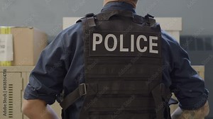 Police officer in a locker room preparing for shift