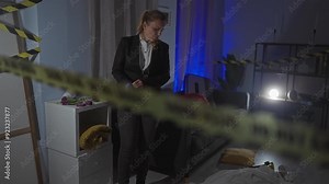 A thoughtful woman detective analyzes a crime scene in a dimly lit room with police tape and evidence markers.