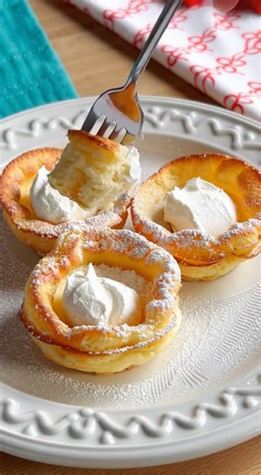 🥞 Mini German Pancakes Ingredients Dry Ingredients: ¾ cup all-purpose flour ½ teaspoon kosher salt ½ teaspoon cinnamon Wet Ingredients: ⅔ cup milk 3 large eggs, room temperature 1 teaspoon vanilla extract For the Tin: 2–3 tablespoons unsalted butter, melted Instructions Preheat and Prep: Preheat your oven to 400°F (200°C). Place about ½ teaspoon of melted butter into each cup of a standard 12-cup muffin tin. Mix the Batter: In a blender or large bowl, combine the flour, kosher salt, cinnamon, m