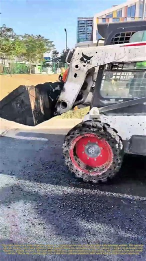 Spreading the Blacktop: How a Skid Steer Places Asphalt on a Road