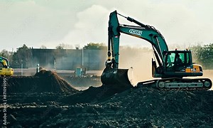 Excavator working on a construction site, digging up the ground as part of earthworks.