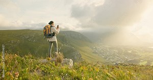 Woman, hiking and video recording on mountains in adventure, wellness and health with nature and cityscape. Person with backpack and trekking photography on green hill, travel or eco friendly journey