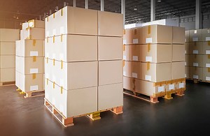 Packaging Boxes Stacked on Pallets in Storage Warehouse. Cartons...
