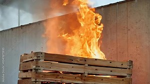 Witness wooden pallet engulfed flames intense footage demonstrating controlled burning safety training exercises captured highdefinition clarity educational purposes fire burn structure concrete