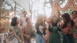 Happy Asian lesbian brides on their wedding day, embracing each other...