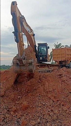 Massive excavator loading dirt into a dump truck — pure power, precision, and hard work in action!