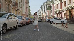 Сontemporari dancer girl Caucasian 20 years dancing on the street. light woman dancing energetically on the street. sunny summer day. 4K