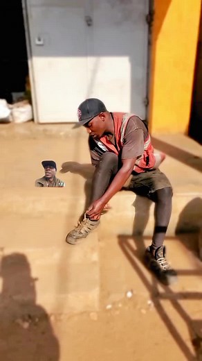 Adjusting Brown Boots in Urban Outdoor Setting