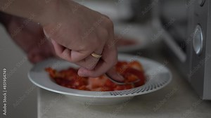 Red strawberry berry in a plate. A man's hand kneads strawberries with a fork in a plate to the consistency of mashed potatoes. High quality 4k footage