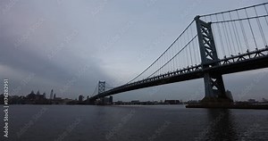 Time-lapse of the Philadelphia skyline behind the Benjamin Franklin Bridge at dusk