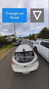 What does the triangle on the road mean?